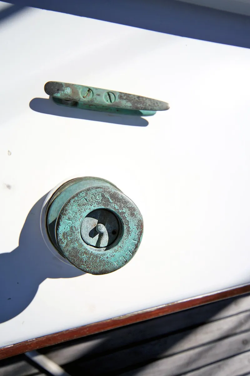 Slide: The Image of Close-up of a 1979 Custom Van Dyne Schooner's weathered metal cleat and fitting. - 12