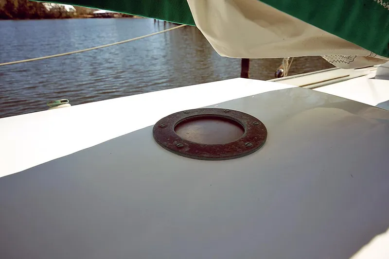 Slide: The Image of 1979 Custom Van Dyne Schooner deck detail with porthole and water view. - 13