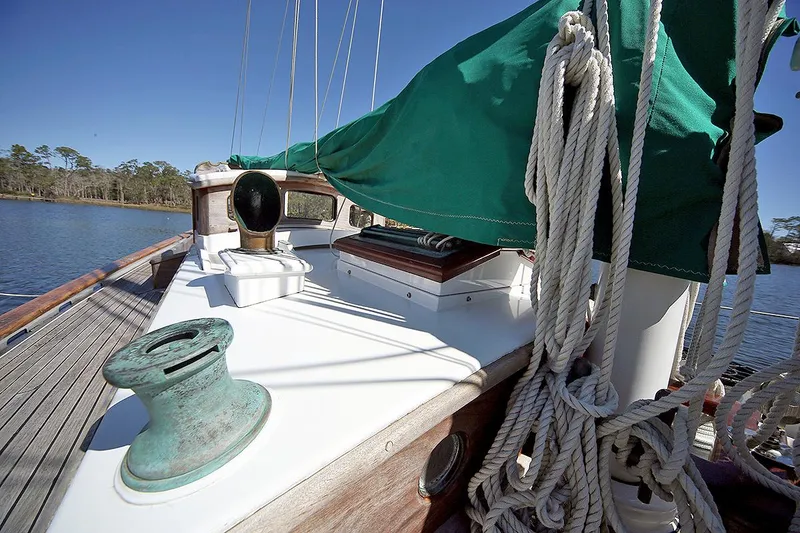 Slide: The Image of 1979 Custom Van Dyne Schooner deck with green sail cover and rigging. - 16
