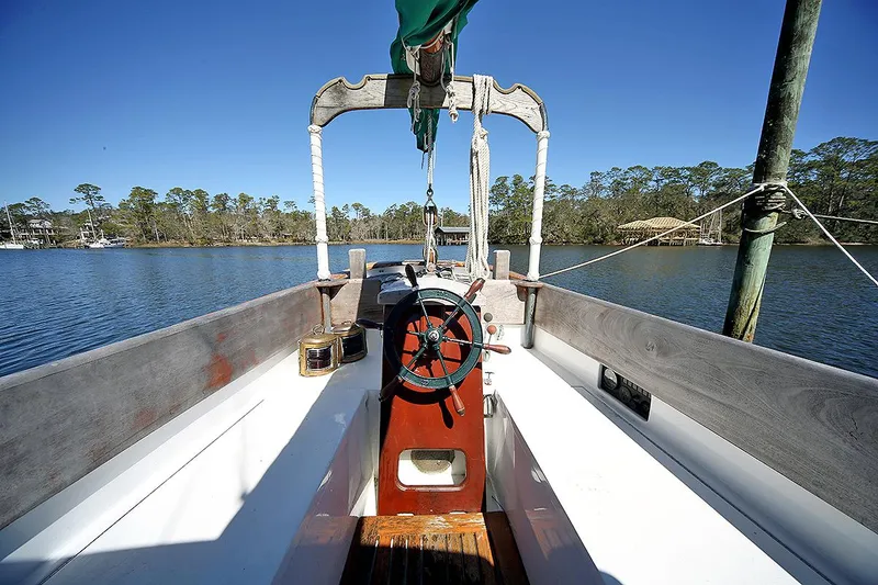 Slide: The Image of 1979 Custom Van Dyne Schooner on a serene lake with clear blue skies. - 18