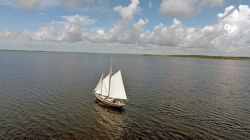 Slide: The Image of 1979 Custom Van Dyne Schooner sailing on a calm sea under a partly cloudy sky. - 3