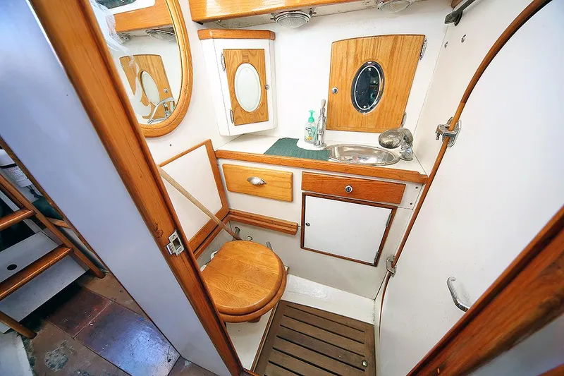 Slide: The Image of 1979 Custom Van Dyne Schooner bathroom with wooden accents and nautical decor. - 31