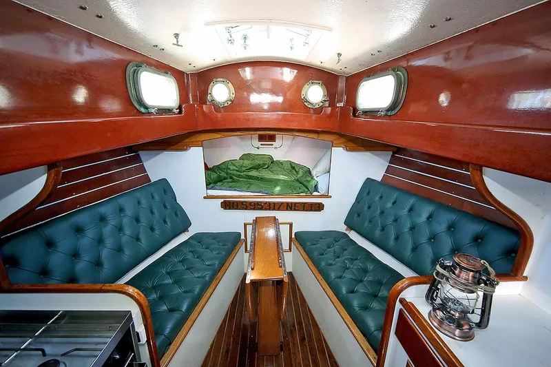 Slide: The Image of Interior of a 1979 Custom Van Dyne Schooner with green cushioned seating. - 42