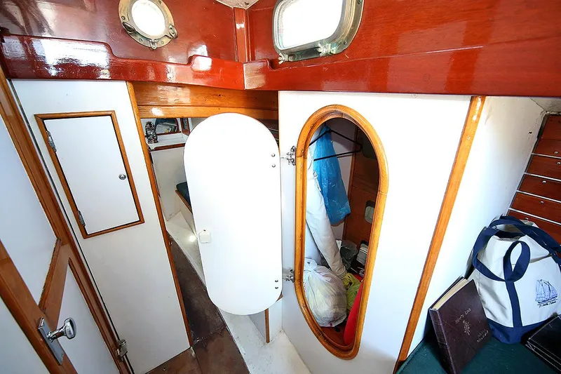 Slide: The Image of 1979 Custom Van Dyne Schooner interior cabin with wooden accents and storage compartments. - 46