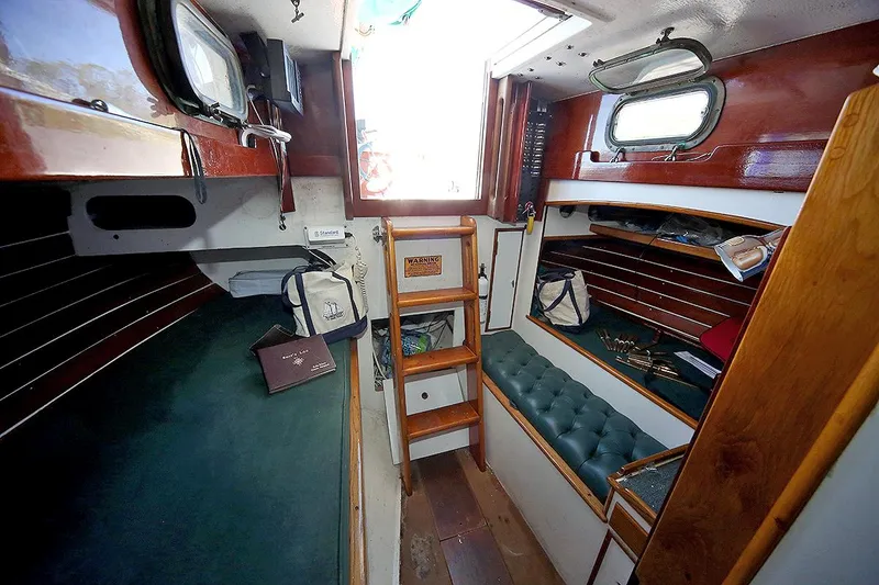 Slide: The Image of 1979 Custom Van Dyne Schooner interior with wooden finishes and green upholstery. - 47
