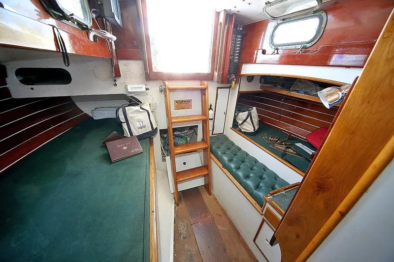 Slide: The Image of Interior of 1979 Custom Van Dyne Schooner with wooden finishes and green upholstery. - 48