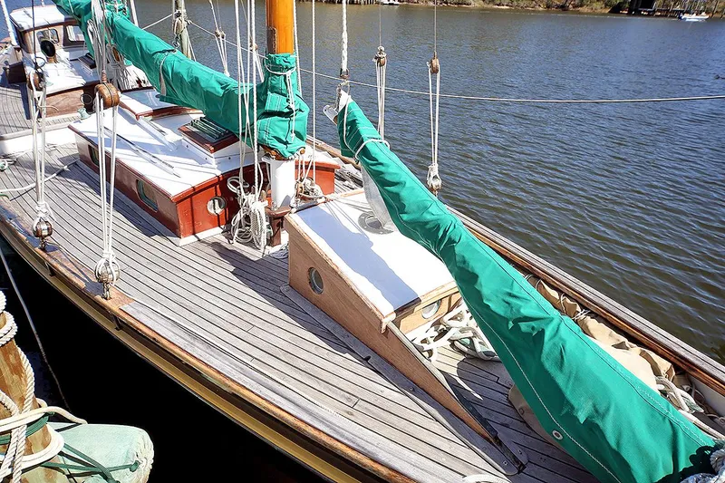 Slide: The Image of 1979 Custom Van Dyne Schooner sailboat docked on calm water. - 8