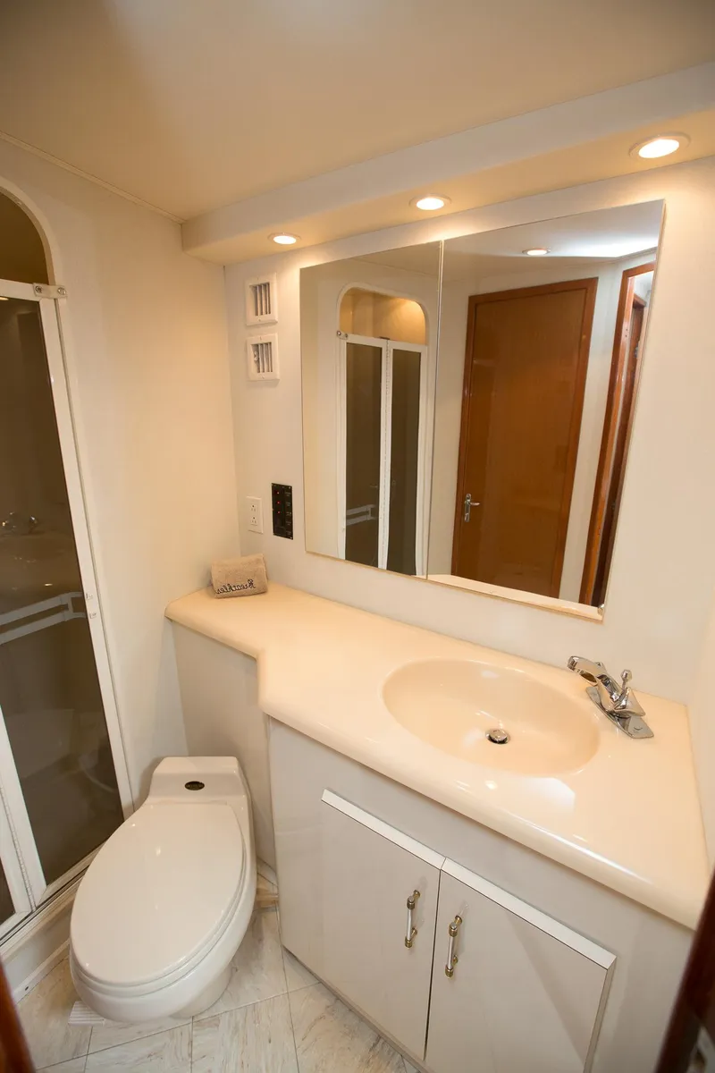 Slide: The Image of Bathroom interior of 2000 Viking 50 Convertible Sport Fisher yacht, featuring sink and toilet. - 28