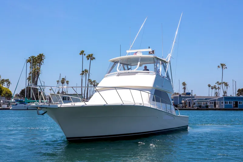Slide: The Image of 2000 Viking 50 Convertible Sport Fisher yacht cruising in sunny marina waters. - 3