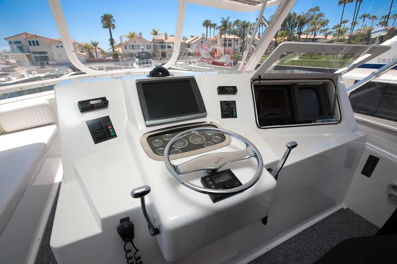 Slide: The Image of Helm of 2000 Viking 50 Convertible Sport Fisher with modern navigation equipment. - 38
