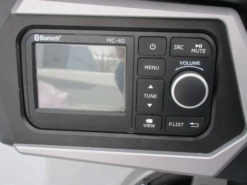 Slide: The Image of 2022 Axis A24 Bluetooth MC-40 audio control panel with display and buttons. - 13