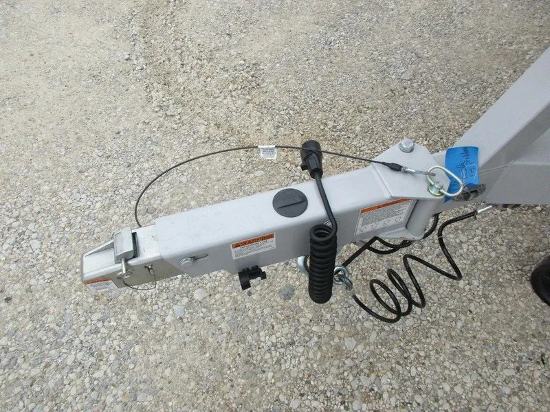 Slide: The Image of Trailer hitch of a 2022 Axis A24 on gravel surface. - 18