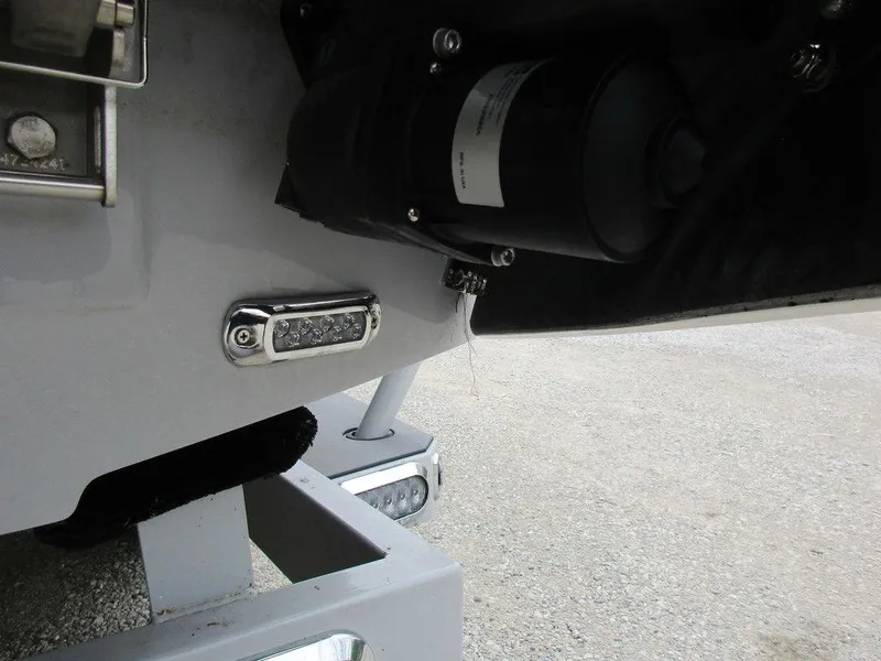 Slide: The Image of 2022 Axis A24 boat detail showing engine and trailer components. - 19