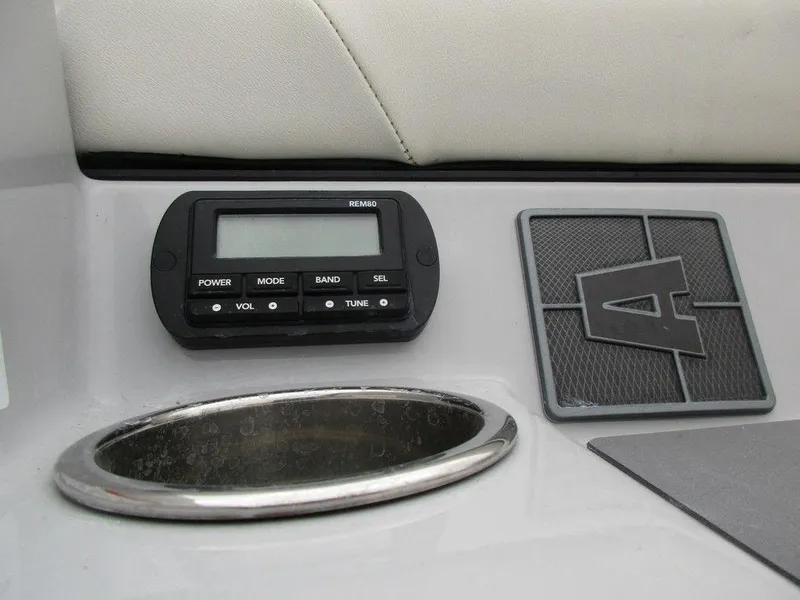 Slide: The Image of 2022 Axis A24 boat dashboard with control panel and cup holder. - 20
