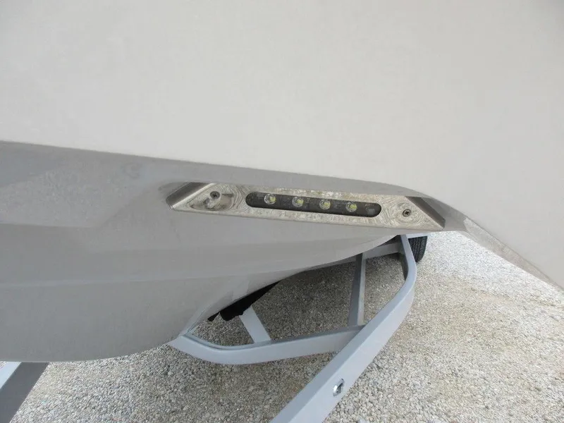 Slide: The Image of 2022 Axis A24 boat trailer with LED lights, parked on gravel. - 22