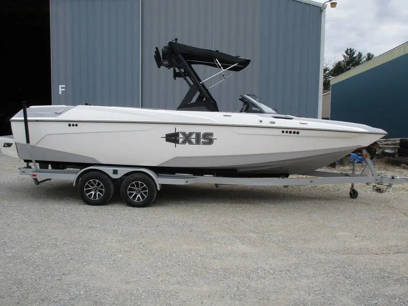 Slide: The Image of 2022 Axis A24 boat on trailer, white exterior, parked outdoors. - 4