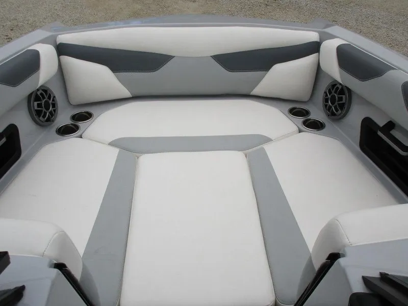 Slide: The Image of 2022 Axis A24 boat interior with gray and white seating, cup holders, and speakers. - 5
