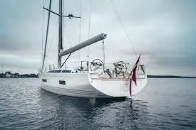 Slide: The Image of 2025 X-Yachts X5.6 sailboat on calm water under cloudy sky. - 2