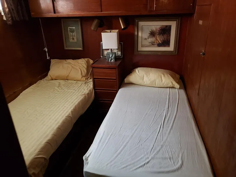 Slide: The Image of 1964 Chris-Craft Constellation cabin with twin beds, wooden interior, and framed artwork. - 23