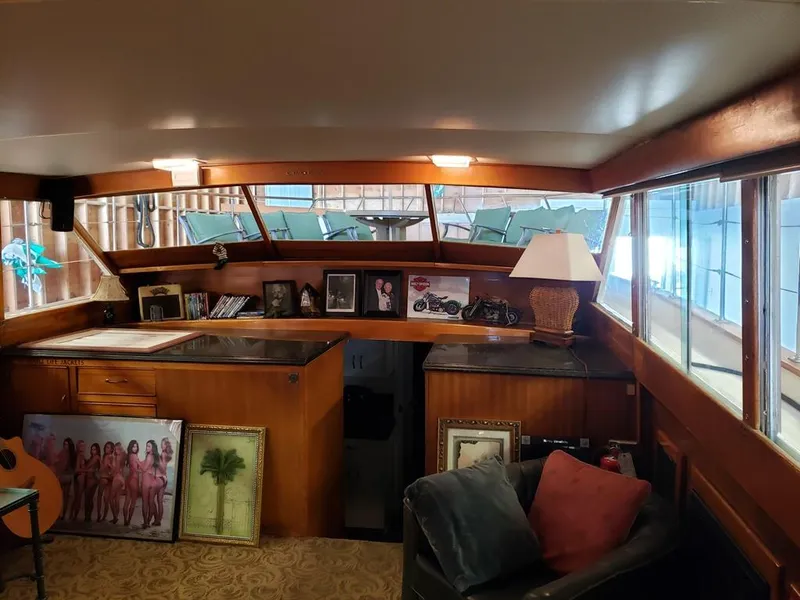 Slide: The Image of Interior of a 1964 Chris-Craft Constellation yacht with wood paneling and framed photos. - 29