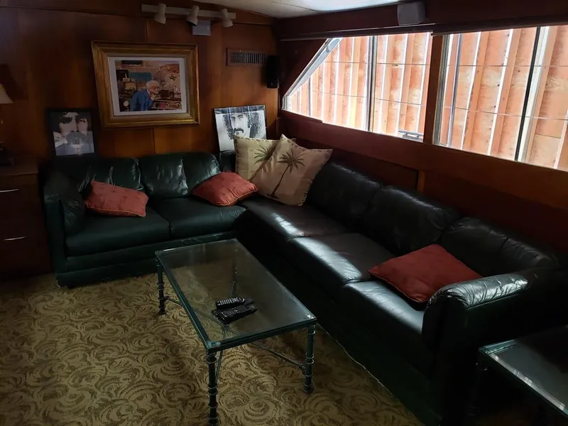 Slide: The Image of Luxurious 1964 Chris-Craft Constellation interior with leather sofas and glass coffee table. - 31