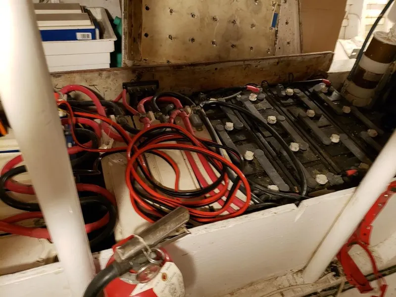 Slide: The Image of Battery compartment of a 1964 Chris-Craft Constellation boat with cables and fire extinguisher. - 37