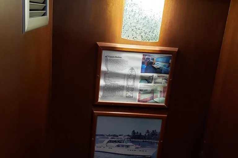 Slide: The Image of 1964 Chris-Craft Constellation interior with framed boat details and photographs. - 44