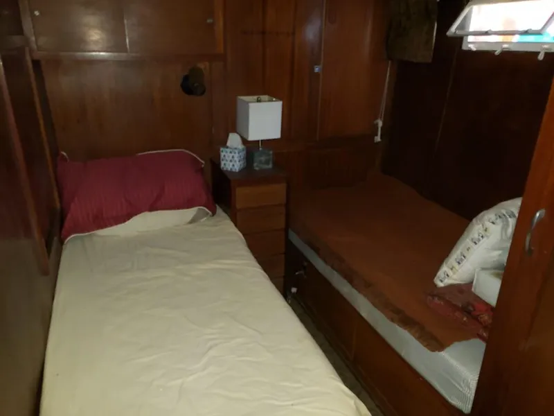 Slide: The Image of 1964 Chris-Craft Constellation cabin interior with twin beds and wooden paneling. - 24