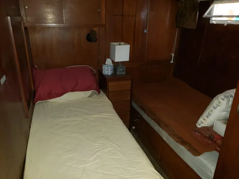 Slide: The Image of 1964 Chris-Craft Constellation cabin interior with twin beds and wooden furnishings. - 25