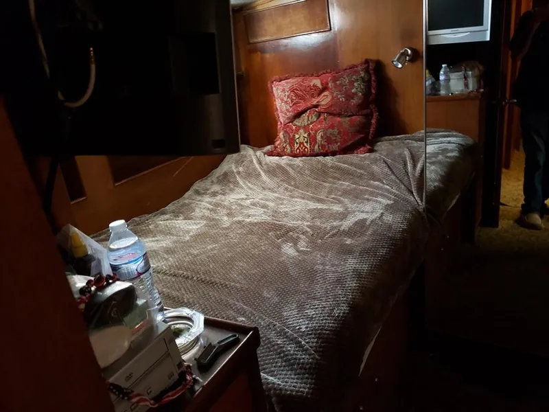 Slide: The Image of Cozy cabin interior of a 1964 Chris-Craft Constellation with a bed and wooden furnishings. - 27