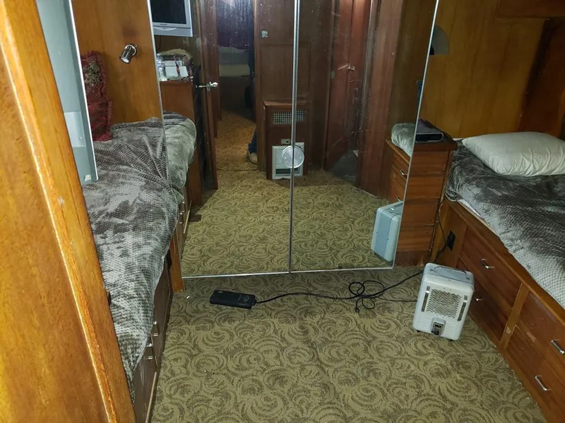 Slide: The Image of 1964 Chris-Craft Constellation cabin interior with twin beds and mirrored closet. - 28