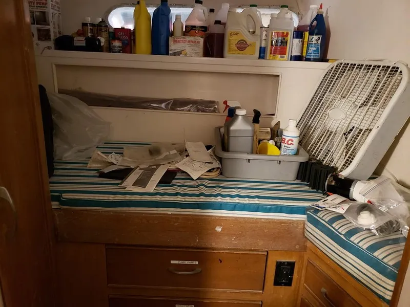 Slide: The Image of Interior of a 1964 Chris-Craft Constellation with cleaning supplies and a fan. - 34