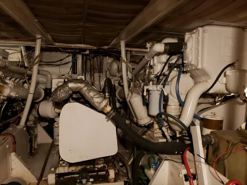 Slide: The Image of Engine room of a 1964 Chris-Craft Constellation boat, showcasing complex machinery and piping. - 36