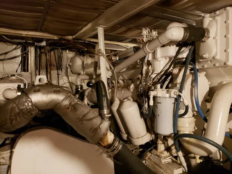 Slide: The Image of Engine room of a 1964 Chris-Craft Constellation boat, showcasing complex machinery and pipes. - 39