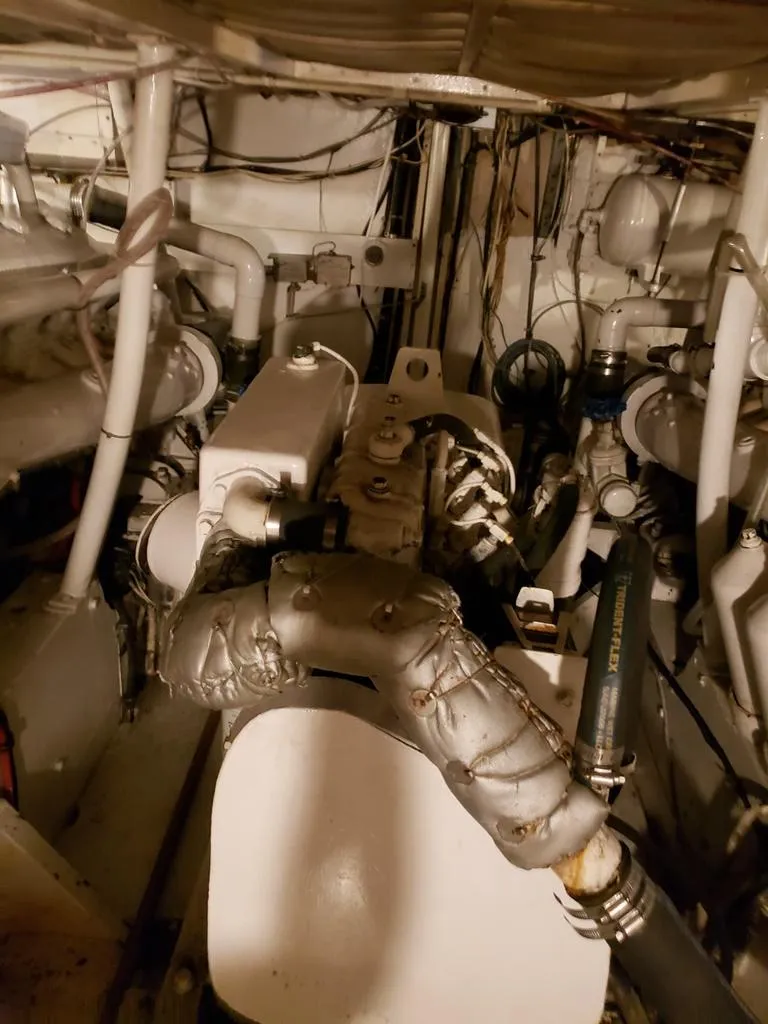 Slide: The Image of Engine room of a 1964 Chris-Craft Constellation boat, showcasing mechanical components and wiring. - 40