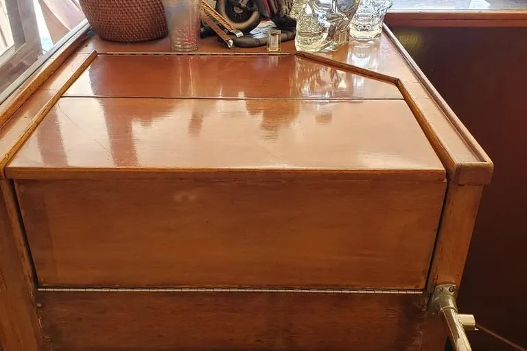 Slide: The Image of 1964 Chris-Craft Constellation wooden interior detail with polished finish and decorative items. - 43