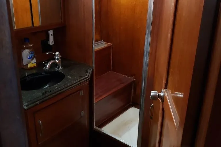Slide: The Image of 1964 Chris-Craft Constellation bathroom with wooden interior and sink. - 46