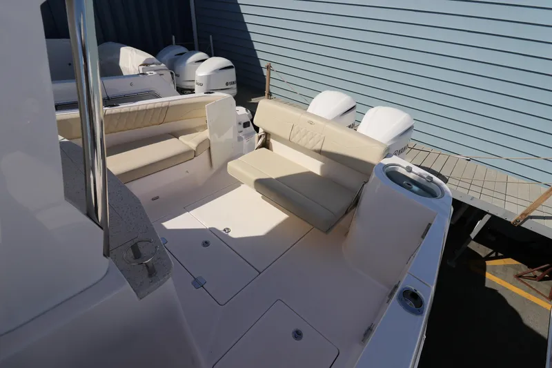 Slide: The Image of 2019 Regal 33 SAV boat with seating area and multiple outboard engines. - 10