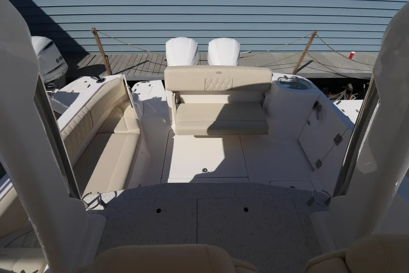 Slide: The Image of 2019 Regal 33 SAV boat interior with seating and twin engines. - 11