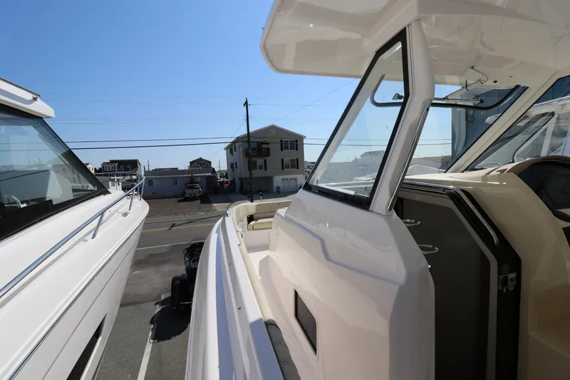 Slide: The Image of 2019 Regal 33 SAV boat docked, showcasing sleek design and modern features. - 13