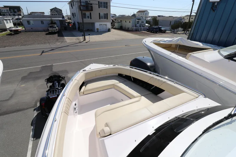 Slide: The Image of 2019 Regal 33 SAV boat with spacious seating, parked near residential area. - 14