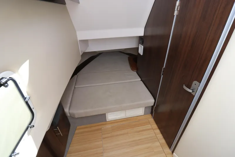 Slide: The Image of 2019 Regal 33 SAV cabin interior with bed and wooden flooring. - 20
