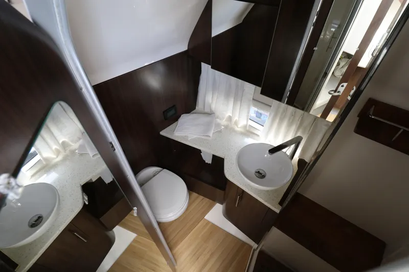 Slide: The Image of Luxurious bathroom interior of 2019 Regal 33 SAV boat with modern fixtures and wood accents. - 23