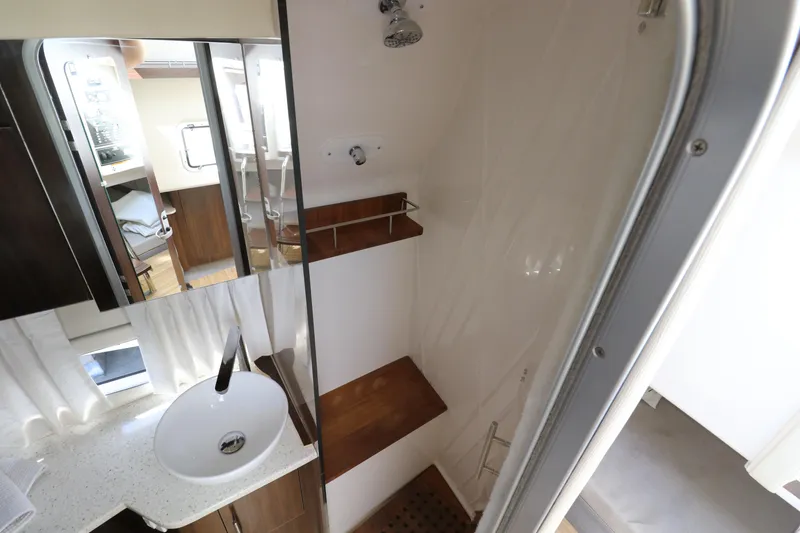 Slide: The Image of 2019 Regal 33 SAV bathroom with modern sink, shower, and wooden accents. - 24