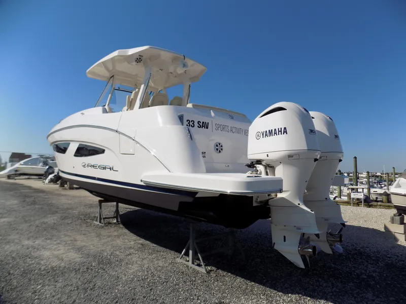 Slide: The Image of 2019 Regal 33 SAV boat with Yamaha engines on display outdoors. - 3