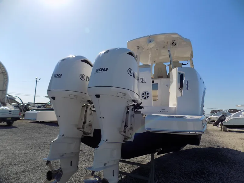 Slide: The Image of 2019 Regal 33 SAV boat with twin Yamaha 300 engines, docked outdoors. - 4