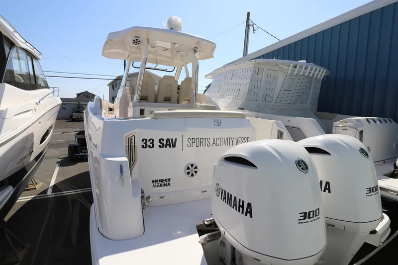 Slide: The Image of 2019 Regal 33 SAV boat with Yamaha engines, docked in a marina. - 8