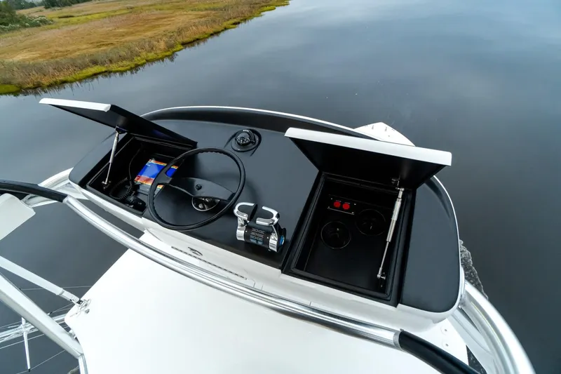 Slide: The Image of Viking 54 yacht helm station, 2025 model, featuring advanced navigation controls and serene water backdrop. - 20