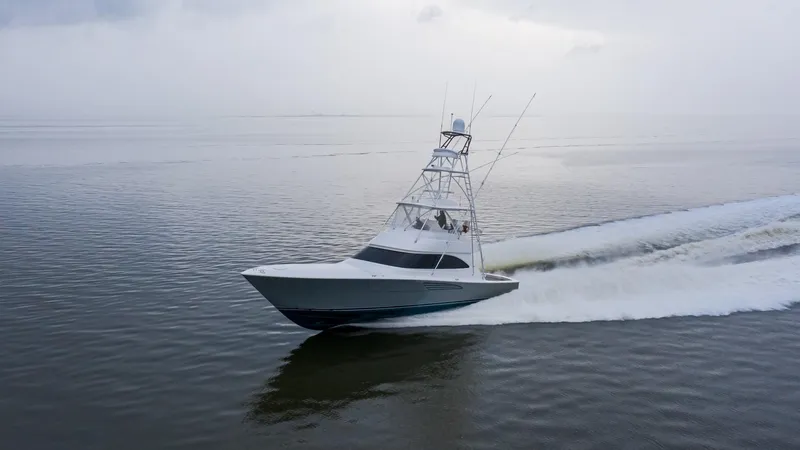 Slide: The Image of 2025 Viking 54 yacht cruising on calm waters. - 3