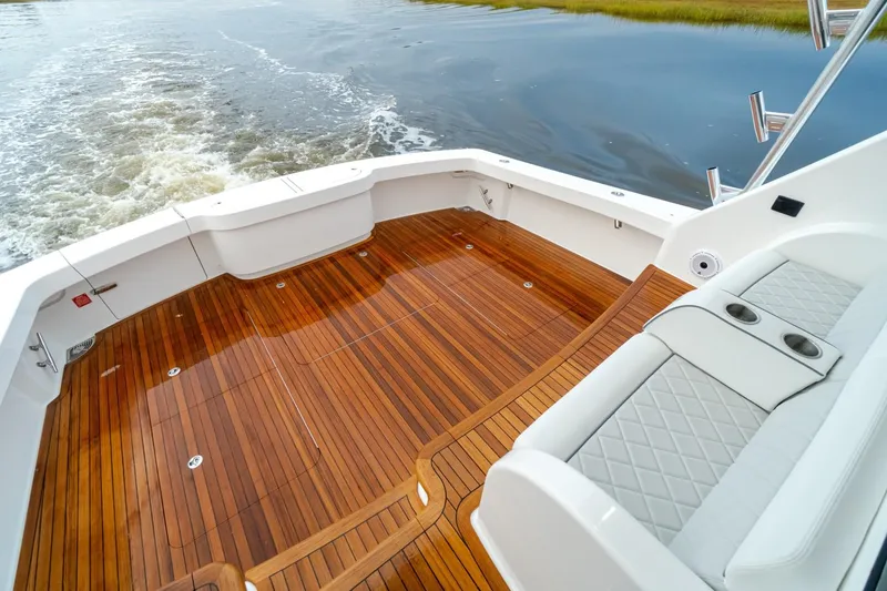 Slide: The Image of Viking 54 2025 boat deck with teak flooring and cushioned seating - 4